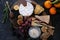 Cheeseboard with a variety of cheeses, crackers, fruit, honey, rosemary sprigs and chutney