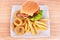 Cheeseburger with chips and onion rings