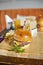Cheeseburger closeup image. Juicy fresh meal on a wooden underlay with the full table setting