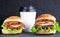 Cheeseburger and cup of coffee on a black stone background. Hamburger with cheese. Burger isolated. Tasty Dinner.Copy space