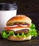 Cheeseburger and cup of coffee on a wooden background. Hamburger with cheese. Burger isolated. Tasty dinner