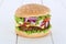 Cheeseburger hamburger tomatoes lettuce cheese wooden board