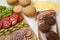 Cheeseburger ingredients on a white wooden background, side view. Close-up