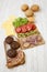 Cheeseburger ingredients on a white wooden background, side view. Close-up