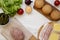 Cheeseburger ingredients on a white wooden background, top view. Overhead, from above, flat lay. Copy space