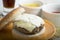 Cheeseburger with mayonnaise, mustard and ketchup on white bowls and soda glass