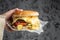 Cheeseburger. melted cheese burger in hand. Fast food take away. copy space