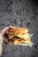 cheeseburger. melted cheese burger in hand. Fast food take away. copy space