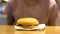 Cheeseburger on table closeup, unhealthy meal, fast food restaurant, dinner
