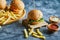 Cheeseburgers with fry potato on the wooden board