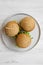Cheeseburgers on grey plate over white wooden background, overhead view. Close-up