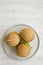 Cheeseburgers on grey plate over white wooden background, top view. Copy space