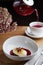 Cheesecake with berry sauce and pouring red tea on background. breakfast morning table with flowers. cottage cheese pancakes