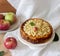 Cheesecake or casserole from cottage cheese with apples, served with apple sauce compote. Rustic style.