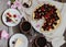 Cheesecake with cherry, two slices on saucers and metal tray on a wooden table. .