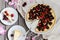 Cheesecake with cherry, two slices on saucers and metal tray on a wooden table. .