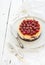 Cheesecake with fresh cherry in ceramic plate over