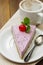 Cheesecake slice with berries and coffee cup, pink cheesecake on wooden background, dessert or breakfast. Sweet food