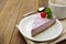 Cheesecake slice with berries and coffee cup, pink cheesecake on wooden background, dessert or breakfast. Sweet food