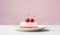 Cheesecake with two cherries on top on a white plate over white minimalist pink background, side view