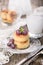 Cheesecakes or cottage cheese pancakes, decorated with berries and mint, lie in a plate on a beautifully decorated table on a