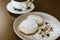 Cheesecakes with icing sugar on a plate on the background of freshly brewed coffee. Wrong tasty sweet sugar breakfast