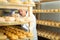 Cheesemaker checking aging process of cheese in maturing chamber