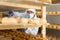 Cheesemaker checking aging process of goat cheese in maturing chamber