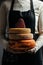 Cheesemaker is controlling the seasoning lots of wheels of cheese. Female hands holding various types of cheese