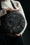 A cheesemaker controls the seasoning of the wheel hard cheese, delicious dairy product. vertical image