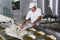 Cheesemaker pours cheese just curdled