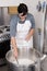 Cheesemaker pours the rennet with a syringe