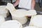 Cheesemaker preparing fresh cheese