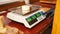 cheesemaker weighs cheese on scales, home production, business. shop