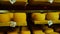 Cheeses stored on wooden shelves