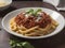 Cheesy Bliss: Generous Parmesan Crowning Al Dente Pasta Bolognese