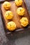 Cheesy Leftover Mashed Potato Muffins on wooden board closeup on the table. Vertical top view
