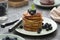 Cheesy pancakes stack with blueberries, healthy breakfast food, dark background