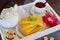 Cheesy pancakes with tea on a wooden tray.