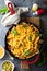 Cheesy pasta bake with ground beef and herbs