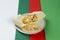 Cheesy shawarma roll served on gray plate, colorful red, white, green abstract background
