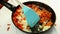 Chef add sliced red pepper, onion, tomato in frying pan. Healthy eating concept. Shakshuka recipe.