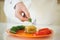 Chef Adding Parsley to a Stuffed Pepper