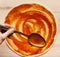 Chef adding sauce, spreading tomato paste on pizza base