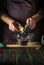 Chef adds cheese to fresh red cabbage salad in a restaurant kitchen. Cooking healthy or vegetarian food