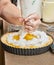 Chef adds cream to Passionflower Pie. French gourmet cuisine