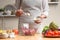 The chef adds mayonnaise to the salad, stir, in the process of a vegetarian salad in the home kitchen. Light background for