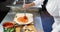 Chef applying sauce on flat bread