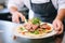 chef assembling a gyro pita with fresh toppings