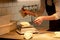 Chef or baker weighing dough on scale at bakery